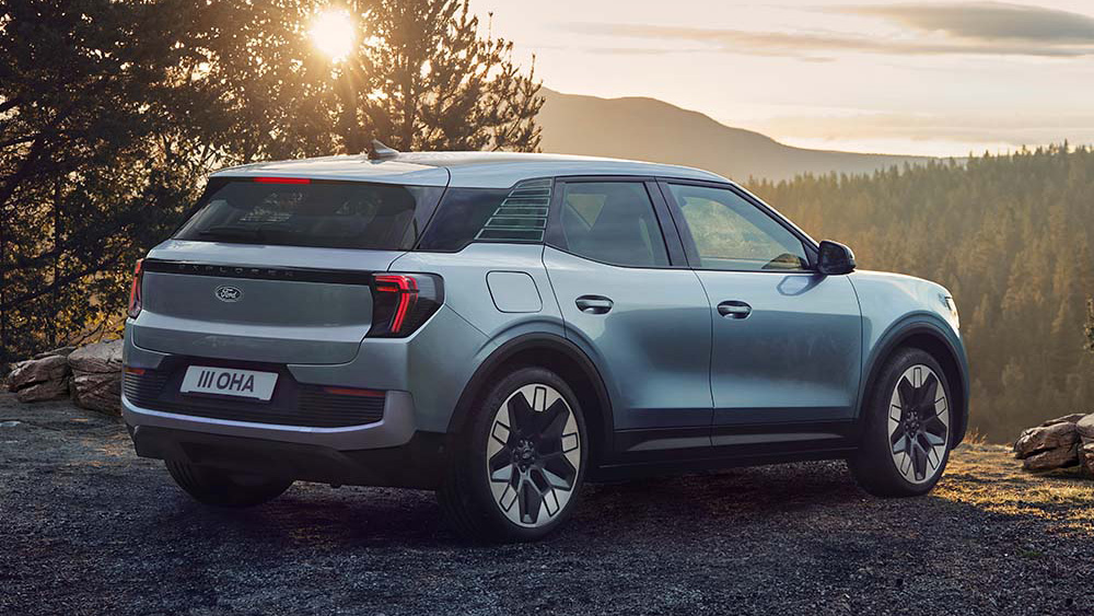 Ford Explorer EV, von hinten, im Wald geparkt.